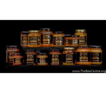 Jars of pure honey stacked on a shelf
